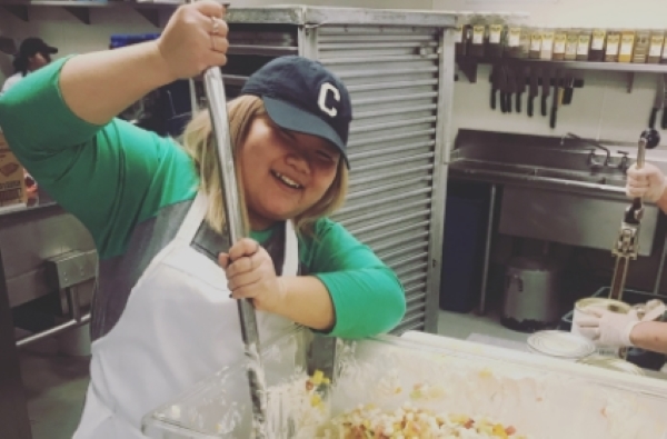 FareStart Volunteer lead Jazmyn mixing food in the kitchen