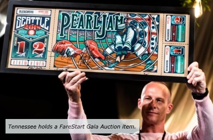 FareStart voluneer and graduate Tennesse holding a Gala auction item