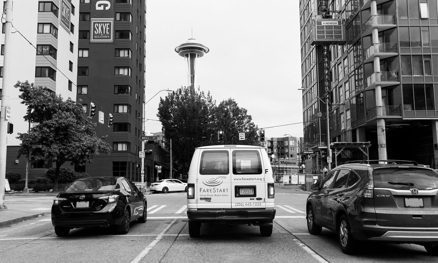 A FareStart delivery van driving through Belltown
