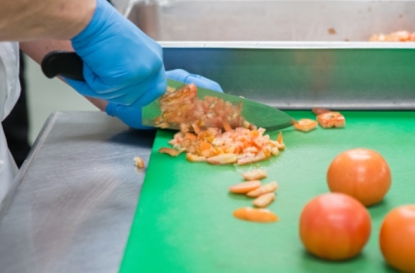 Dicing orange peels in the FareStart kitchen