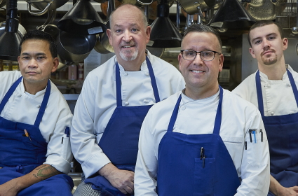 Executive Chef of the Rainier Club with three FareStart Adult Culinary Program graduates