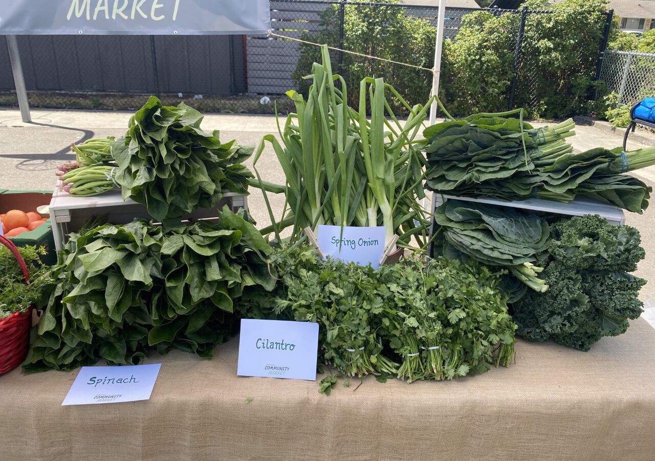 A selection of herbs and veggies displayed at the Mobile Community Market