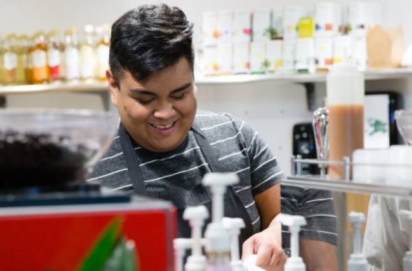 A student of the FareStart Youth and Young Adult Barista Program working the espresso machine