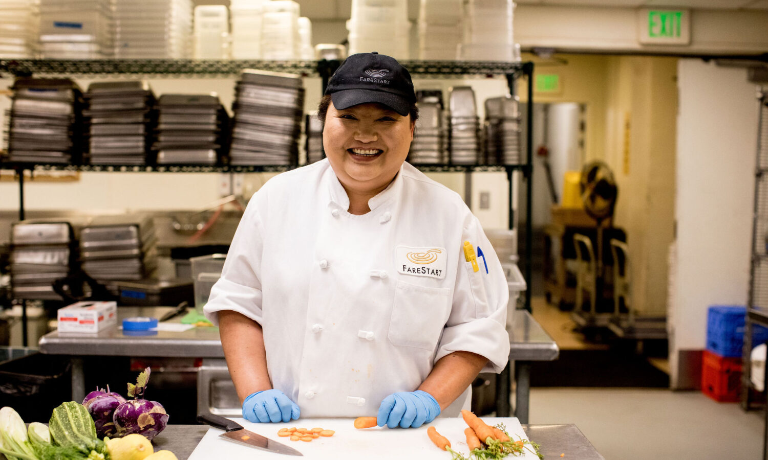 Chef Laura chopping carrots in the kitchen