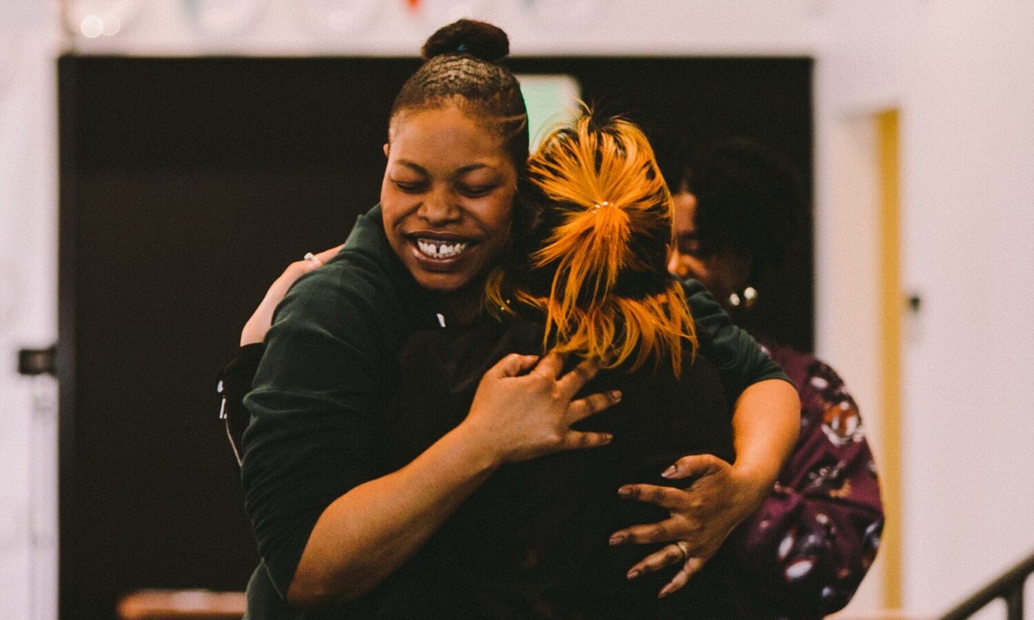 A student and staff member celebrating at FareStart's Barista & Customer Service Program graduation