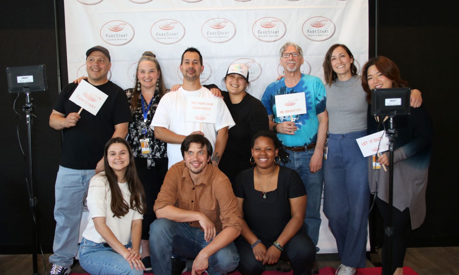 A group of FareStart graduates and trainers smiling during graduation