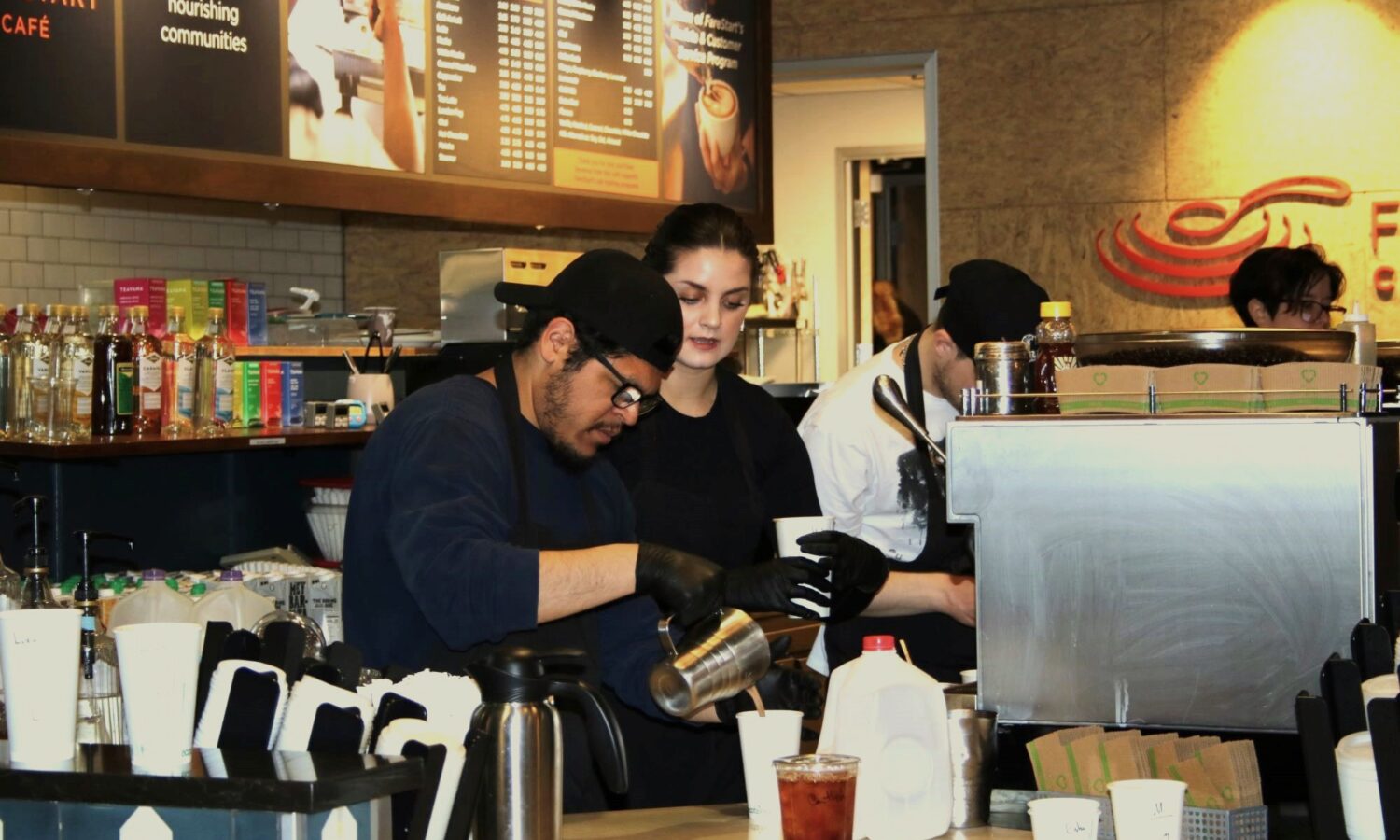 FareStart Barista & Customer Service Program student and staff trainer making drinks in the FareStart Café