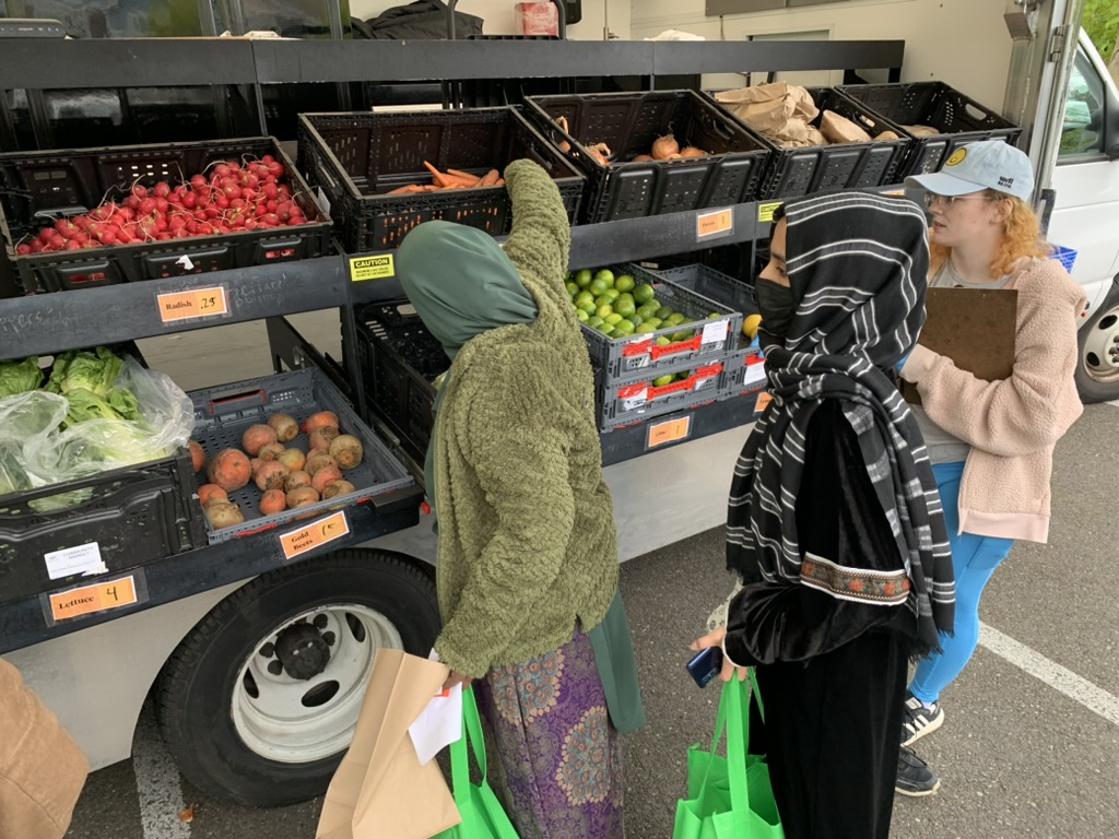 Customers collecting fresh produce at the Mobile Community Market