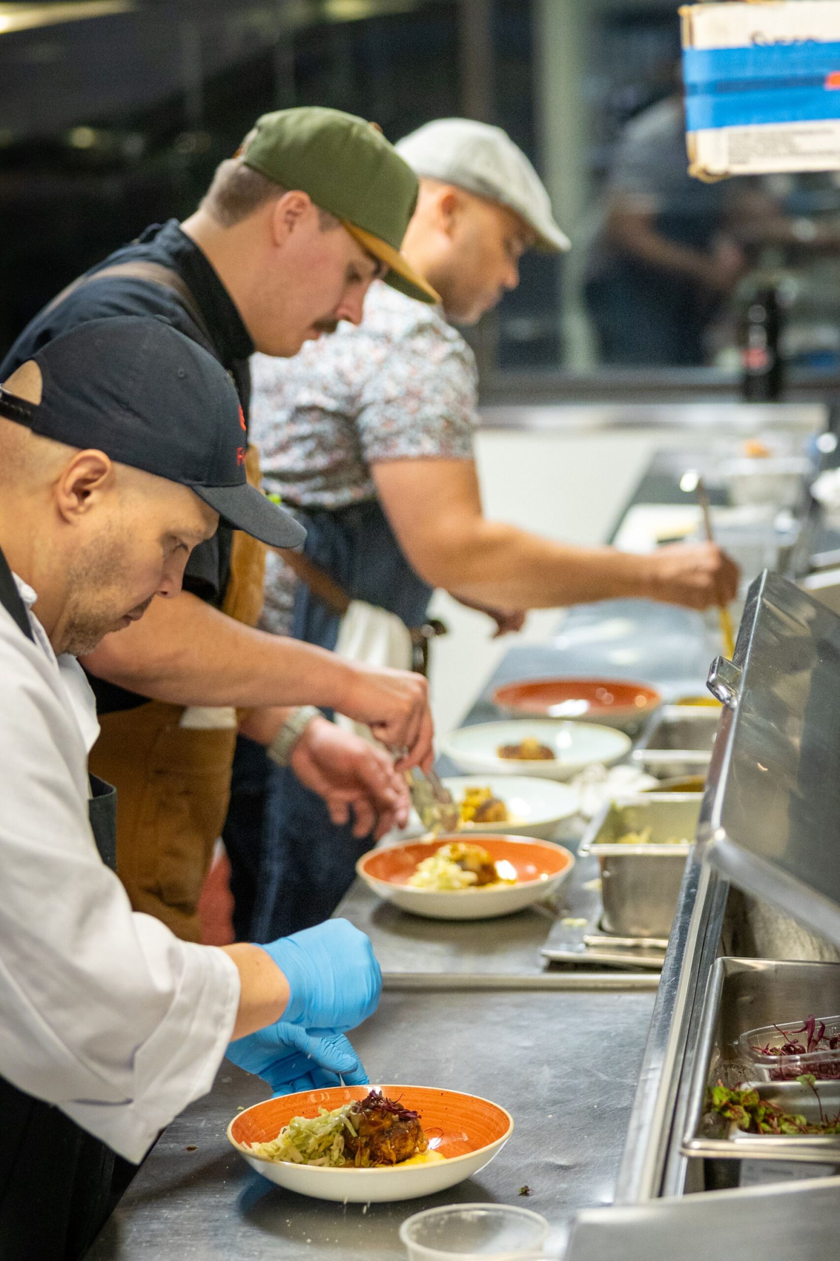 FareStart student and Guest Chef Matt Lewis plating dishes