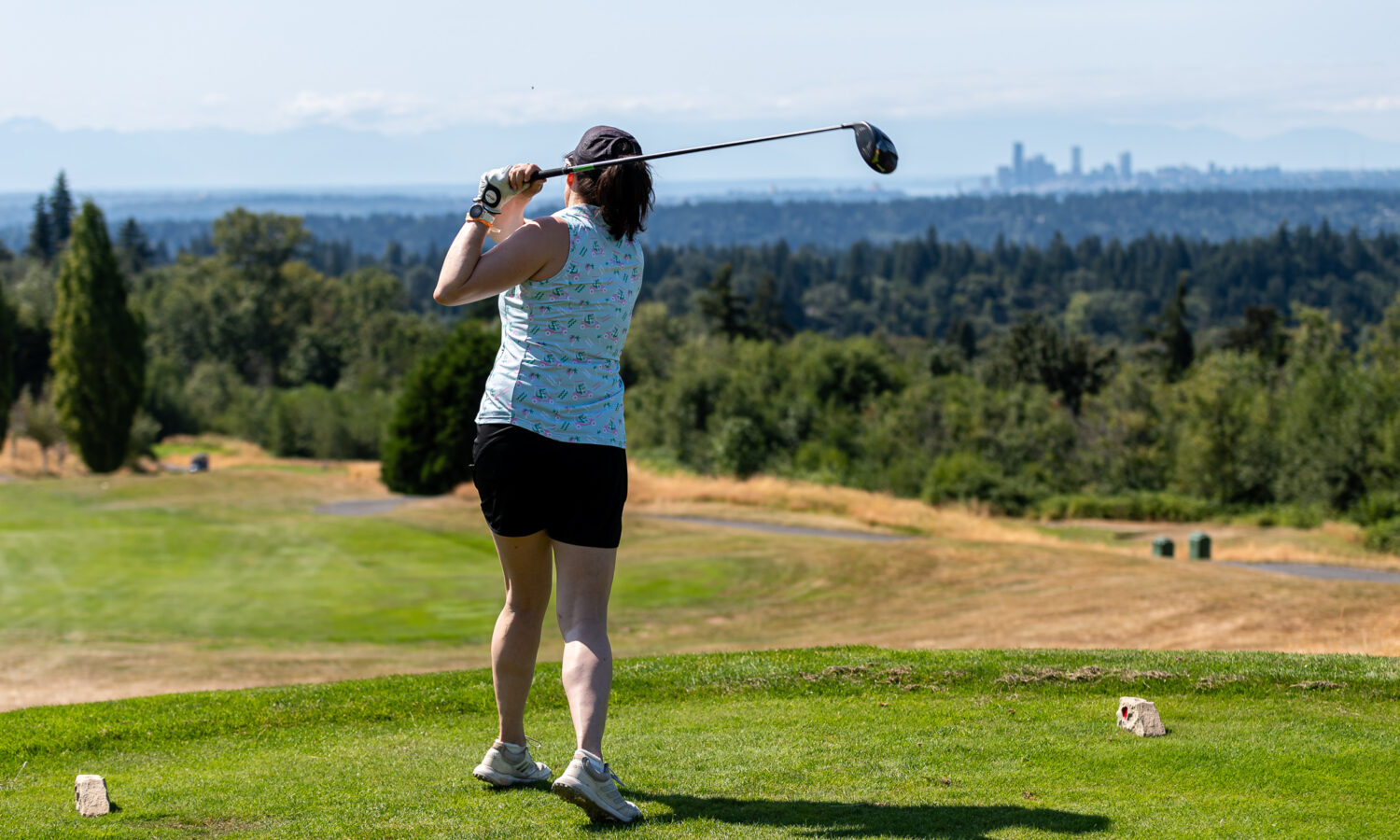 Amazon employee teeing off at the Amazon Golf Tournament