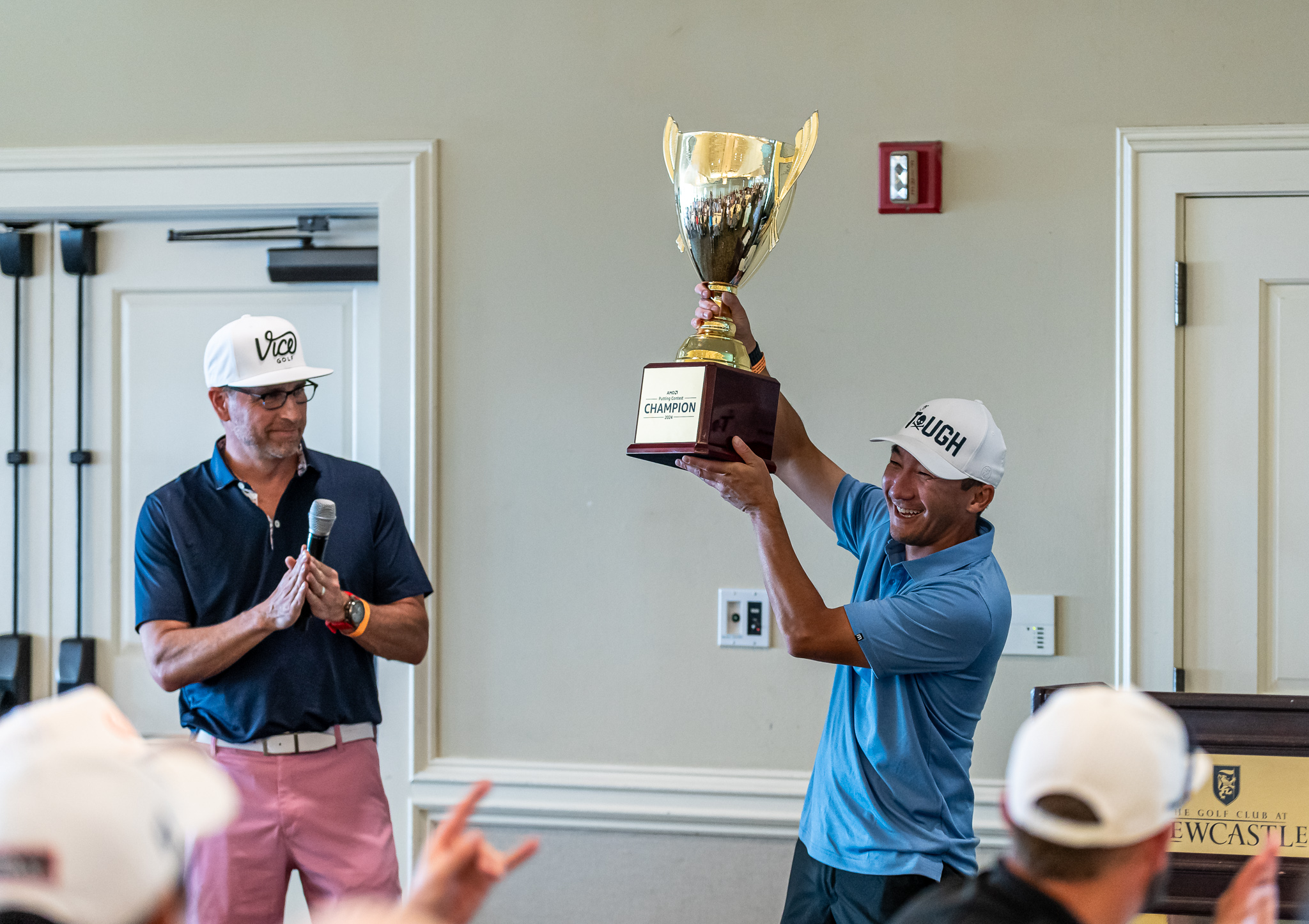 Champion Amazon employee holding his trophy at the Amazon Golf Tournament