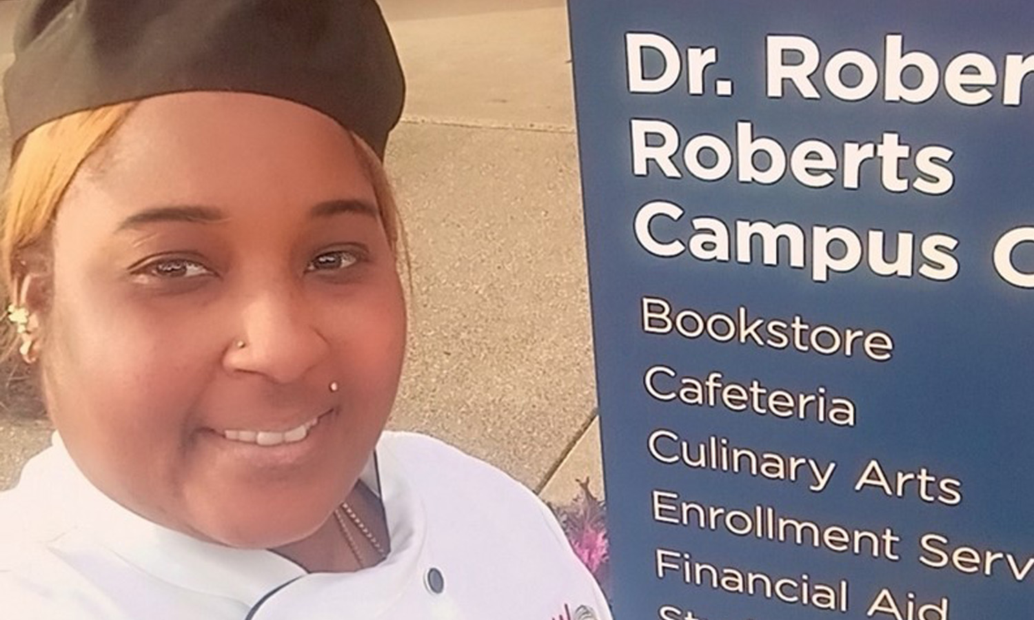 A selfie of Row in front of a sign for RTC