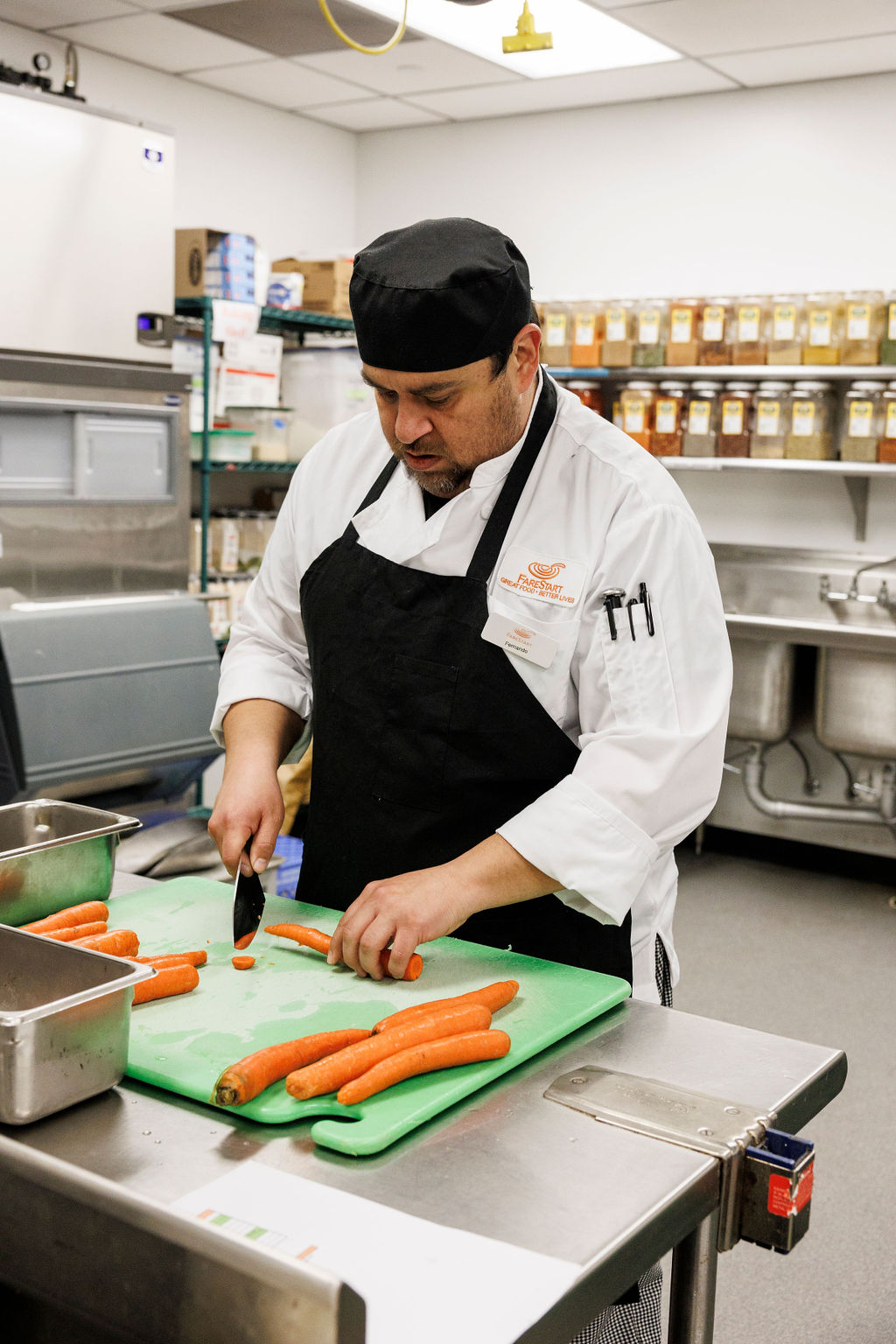 Food Pathways Program student cutting carrots