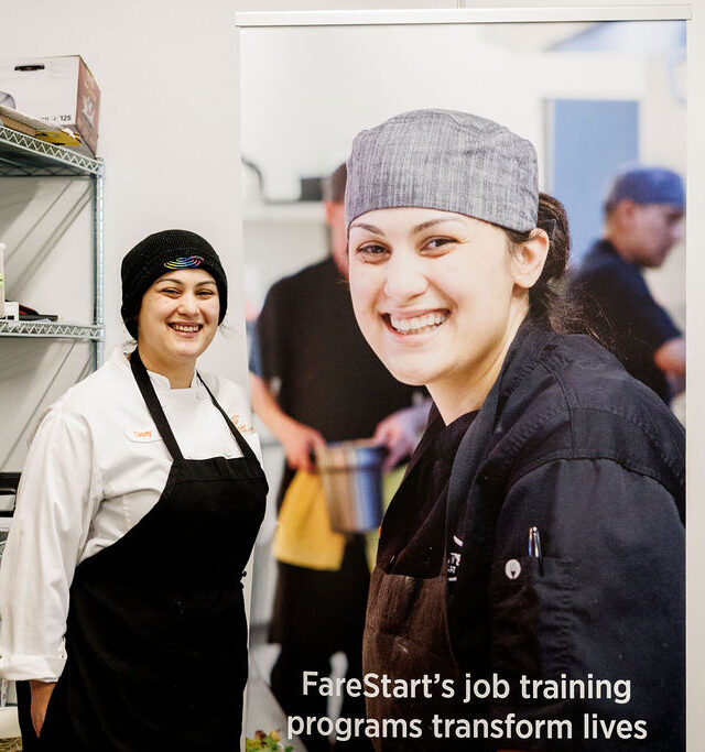 Chef Casey smiling next to a banner of her smiling