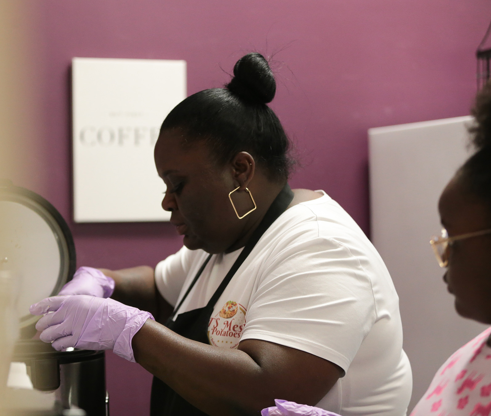 FareStart graduate LaTanya with her daughter preparing food in a class