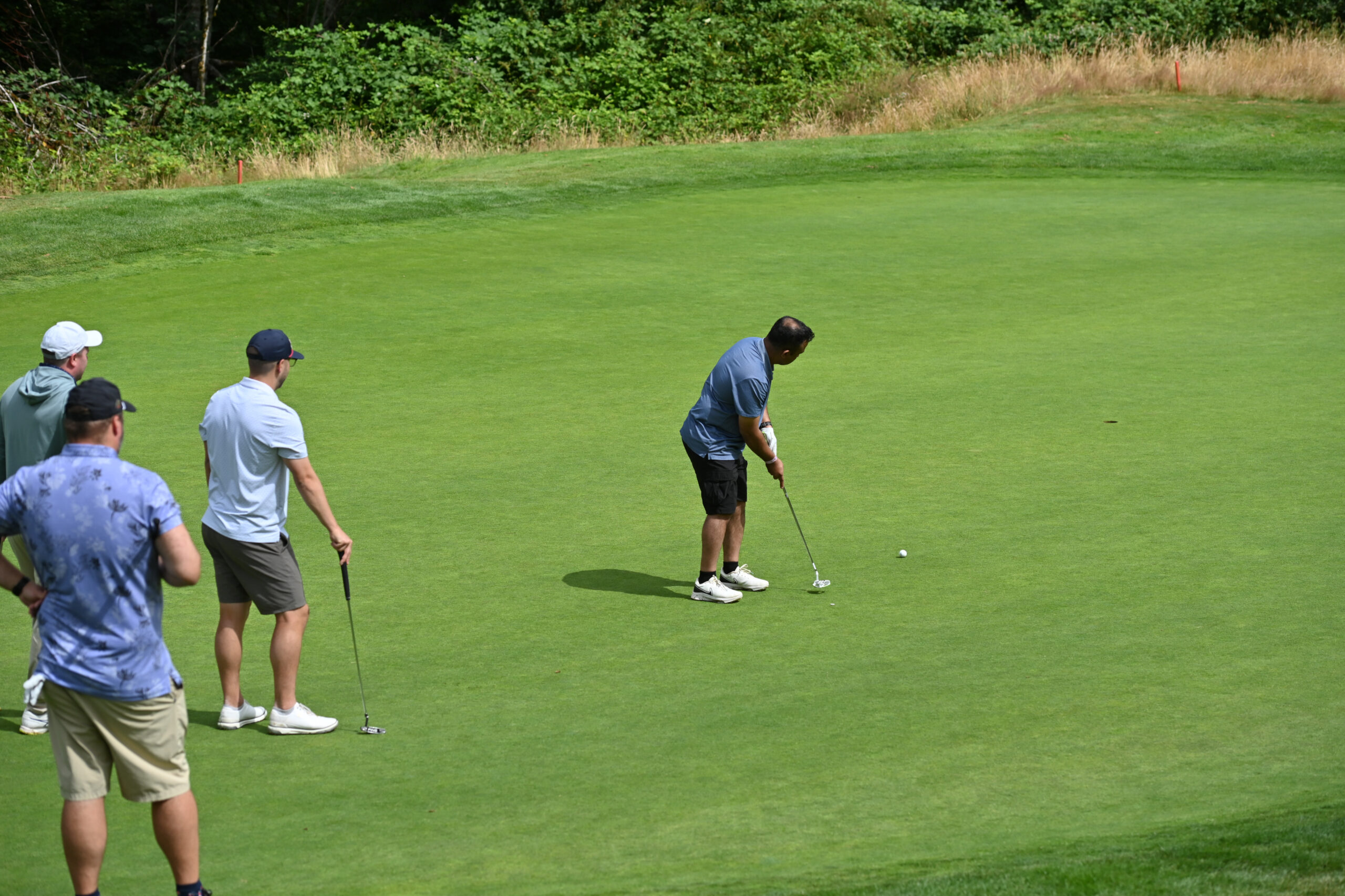 Amazon employees golfing during the Amazon Annual Golf Tournament benefiting FareStart