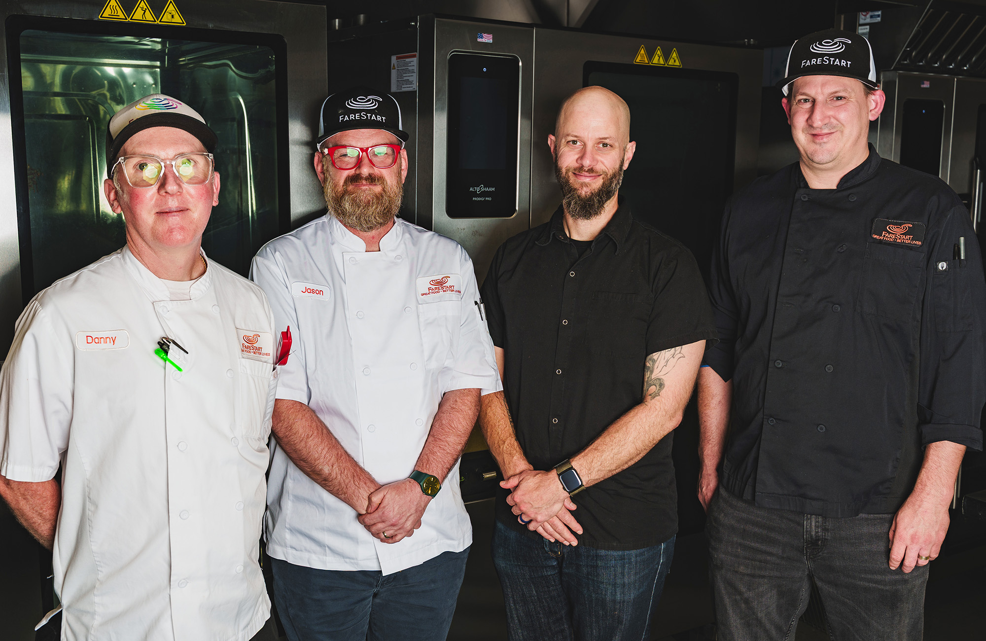 Four FareStart chefs standing next to each other smiling at the camera