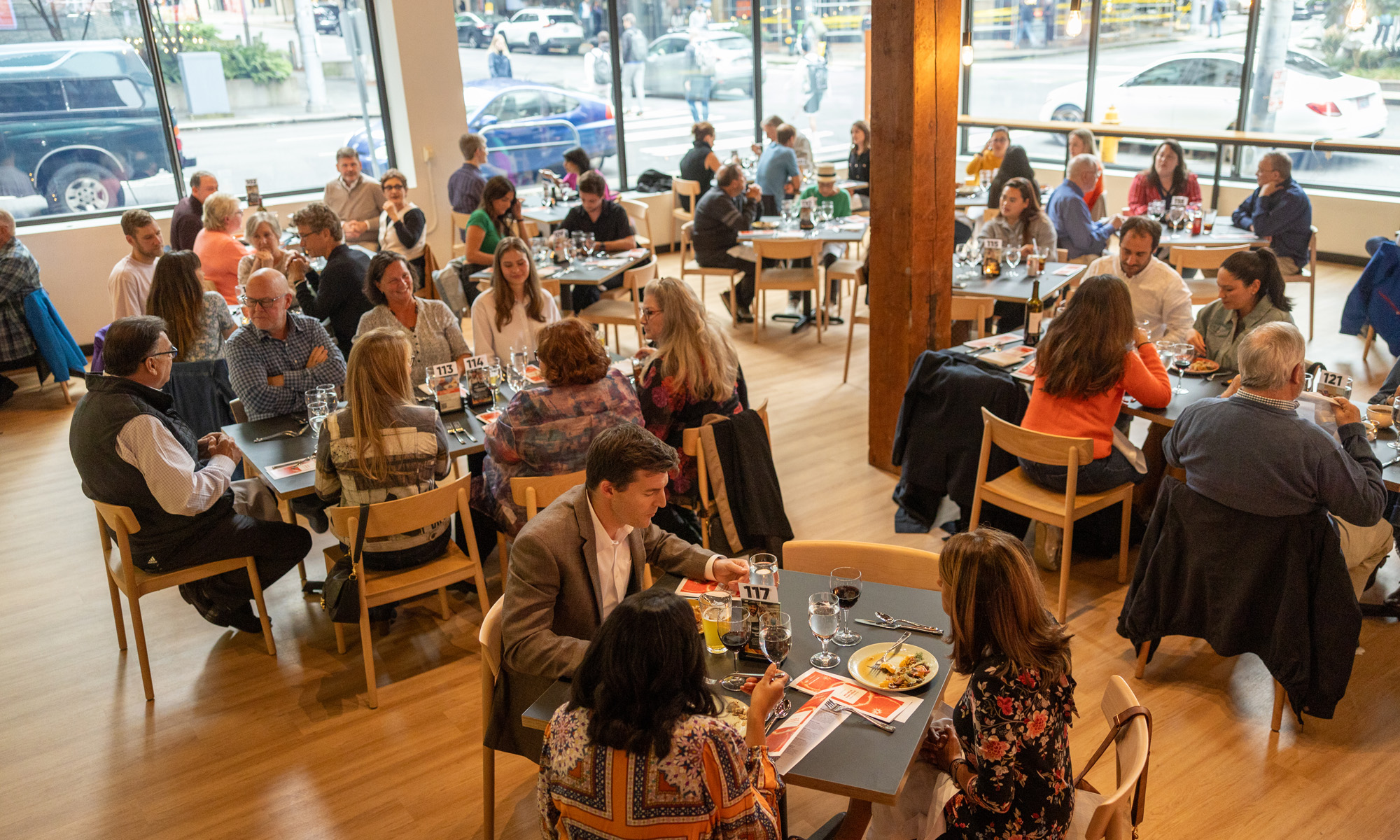 Guests dining, laughing and smiling at the FareStart Restaurant for Guest Chef Night