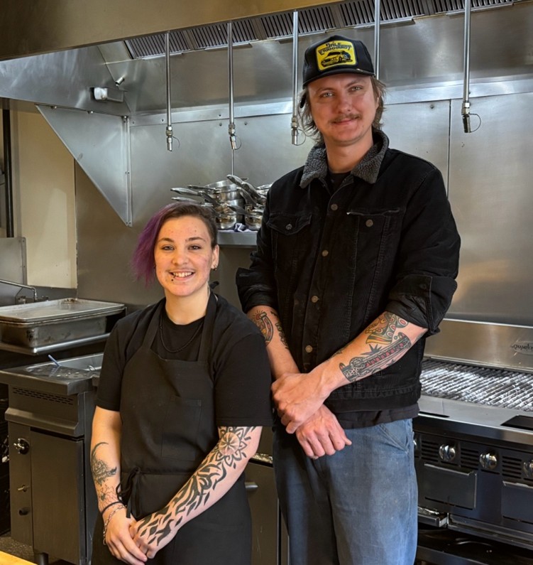 Aries, a FareStart graduate, with Raccolto Executive Chef Liam Byres in a commercial setting