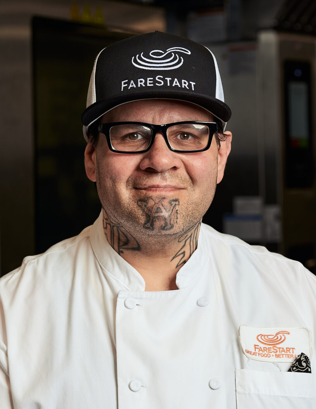 Damian, job training graduate smiling while wearing a chef
