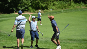 Amazon employees celebrating on the green during the 2026 Amazon Annual Golf Tournament benefiting FareStart