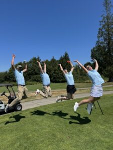 Amazon employees jumping in the air at the annual amazon golf tournament supporting FareStart